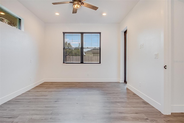 spare room featuring ceiling fan, a healthy amount of sunlight, and light hardwood / wood-style floors