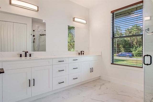 bathroom with vanity and a shower with shower door