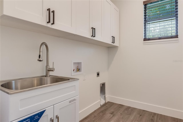 clothes washing area featuring electric dryer hookup, cabinets, sink, hookup for a washing machine, and wood-type flooring