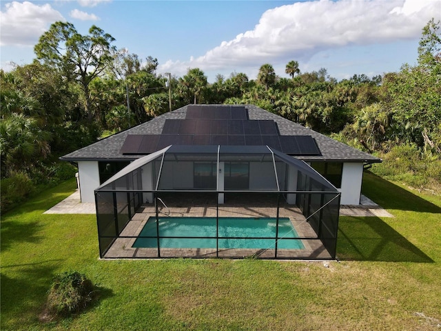 back of property with a lanai, a patio area, and a lawn