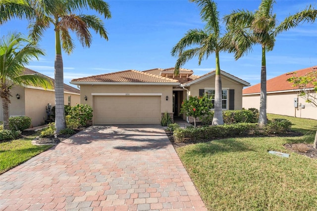 view of front of home featuring a garage and a front yard