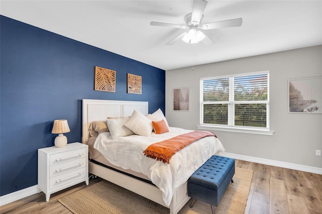 bedroom with light hardwood / wood-style flooring and ceiling fan