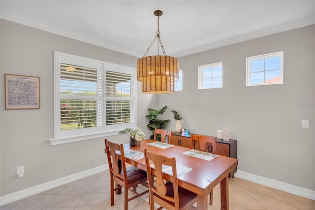 dining area with light tile patterned floors, crown molding, and a healthy amount of sunlight