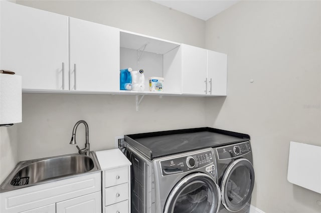 laundry area featuring cabinets, independent washer and dryer, and sink