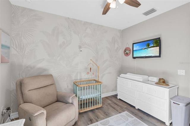 bedroom with visible vents, ceiling fan, baseboards, and wood finished floors