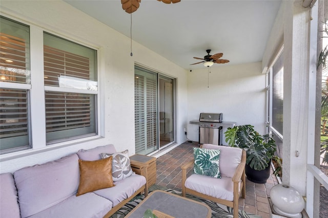 sunroom featuring ceiling fan