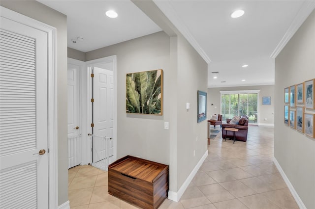 corridor with ornamental molding, recessed lighting, baseboards, and light tile patterned floors