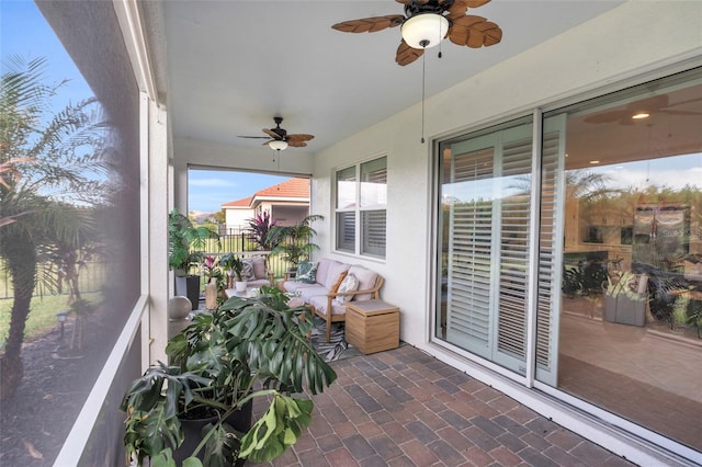 sunroom with a ceiling fan