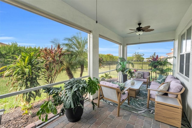 sunroom featuring ceiling fan