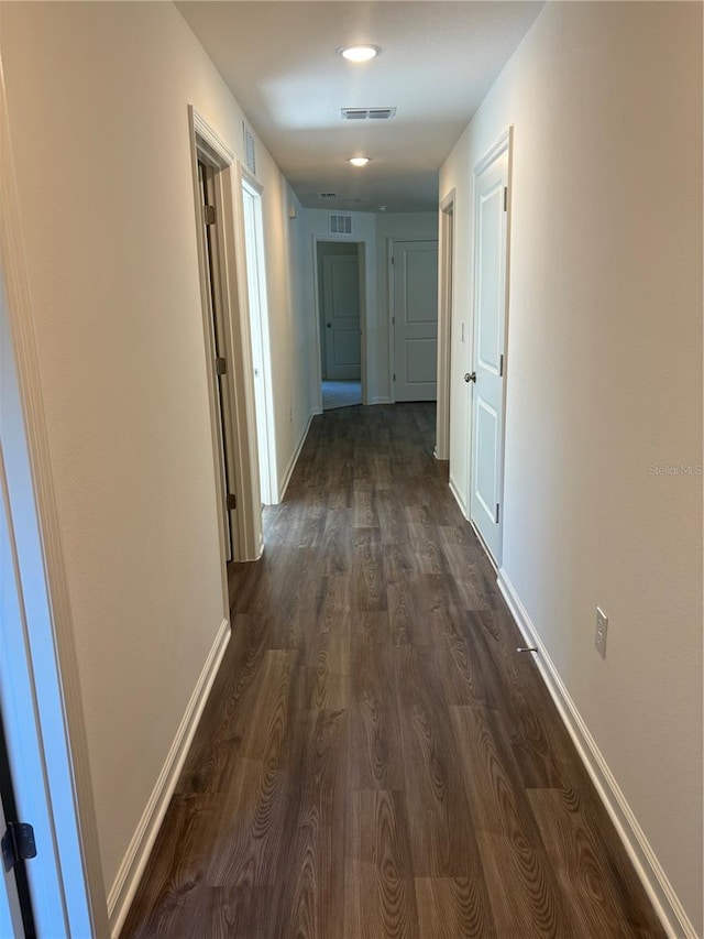 corridor featuring dark hardwood / wood-style floors