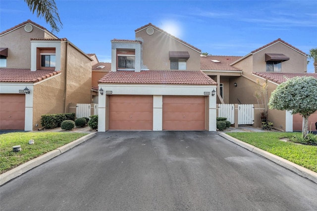 view of front of property featuring a front yard and a garage