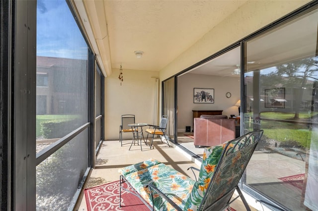 sunroom / solarium with a wealth of natural light and ceiling fan