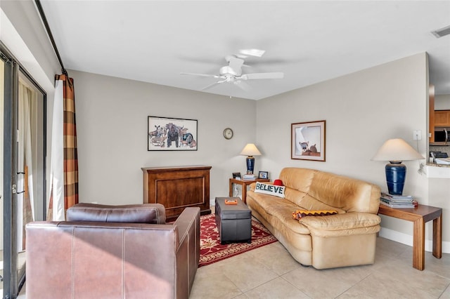 living room featuring ceiling fan and light tile patterned floors