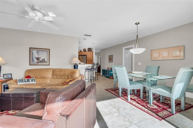 living room with ceiling fan and light tile patterned floors