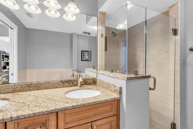 bathroom with vanity and a shower with shower door