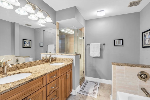 bathroom featuring tile patterned floors, vanity, and separate shower and tub