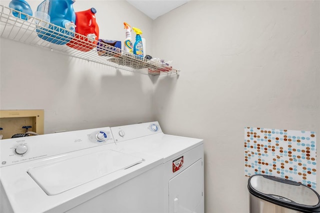 clothes washing area with separate washer and dryer