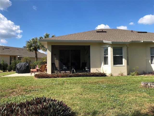 rear view of property with a patio area and a yard