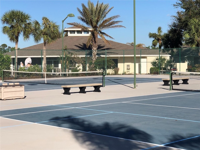 view of tennis court featuring basketball hoop