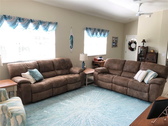 living room with ceiling fan, vaulted ceiling, and hardwood / wood-style flooring