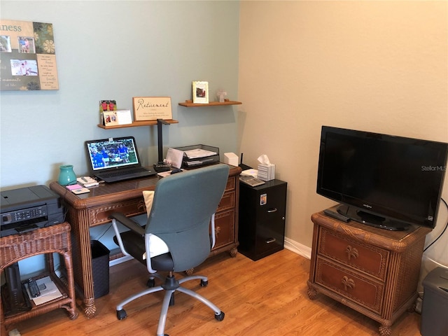 office with light hardwood / wood-style floors