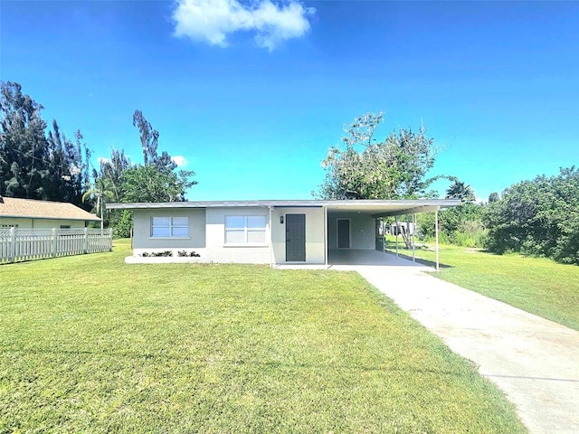 ranch-style house with a front yard and a carport