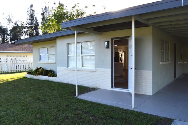 property entrance with a yard