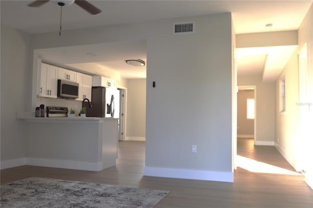 unfurnished living room with ceiling fan and light hardwood / wood-style flooring