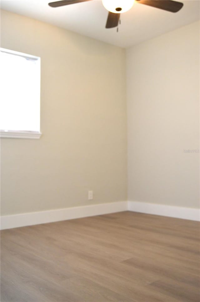 empty room featuring ceiling fan and wood-type flooring