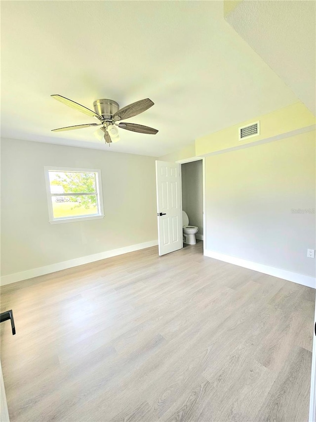 empty room featuring ceiling fan and light hardwood / wood-style floors