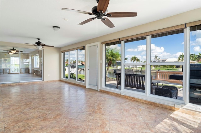 spare room featuring a water view and ceiling fan