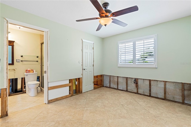 tiled spare room featuring ceiling fan