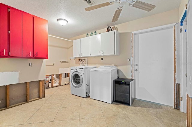 laundry area featuring cabinets, a textured ceiling, ceiling fan, washing machine and dryer, and light tile patterned flooring