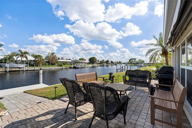 view of patio / terrace with a boat dock, a water view, and grilling area