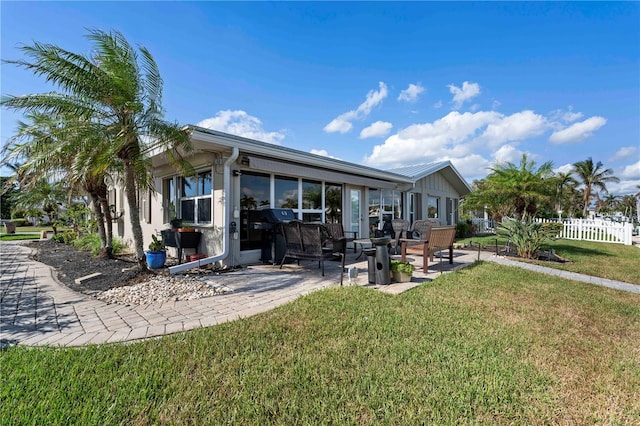 back of house featuring a yard and a patio area