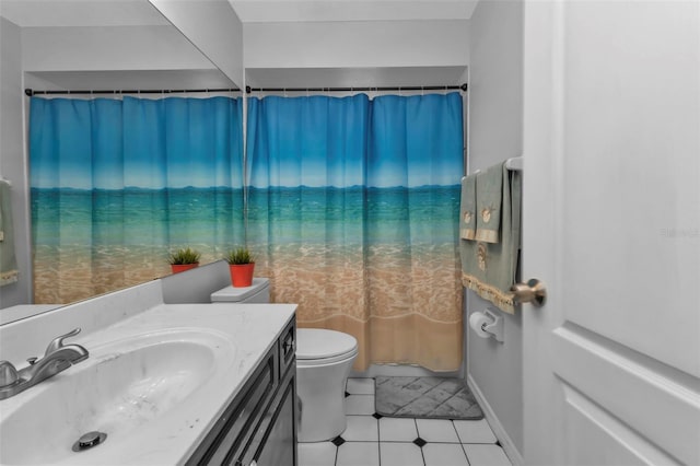 bathroom with tile patterned flooring, vanity, and toilet