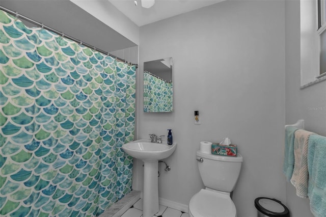 bathroom featuring tile patterned floors, toilet, and walk in shower