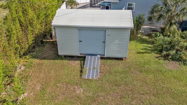 view of outbuilding featuring a yard