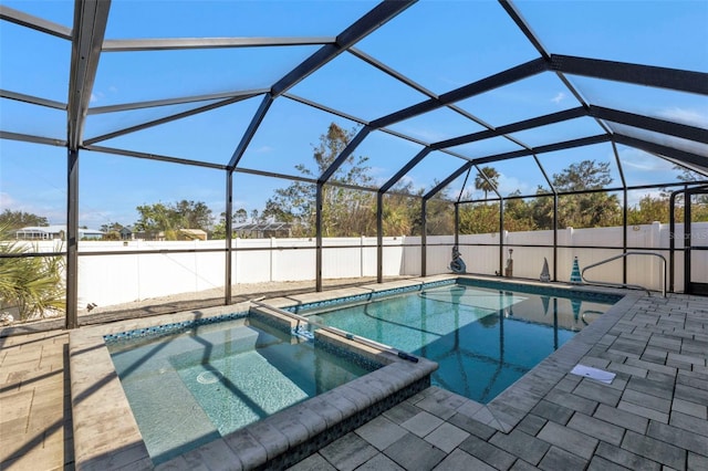 5198 White Ave, Port Charlotte, FL 33981 - view of pool featuring a pool with connected hot tub, a patio area, a fenced backyard, and glass enclosure