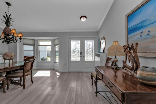 5198 White Ave, Port Charlotte, FL 33981 - foyer entrance featuring ornamental molding, light wood finished floors, baseboards, french doors, and a chandelier