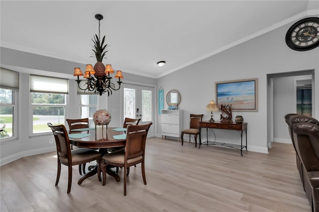 5198 White Ave, Port Charlotte, FL 33981 - dining room featuring vaulted ceiling, light wood-type flooring, a chandelier, ornamental molding, and baseboards