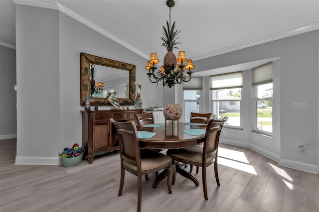 5198 White Ave, Port Charlotte, FL 33981 - dining area with light wood-style floors, baseboards, a chandelier, and crown molding