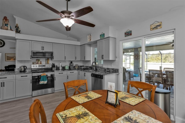 5198 White Ave, Port Charlotte, FL 33981 - kitchen with appliances with stainless steel finishes, a sink, lofted ceiling, ceiling fan, and light wood-style flooring