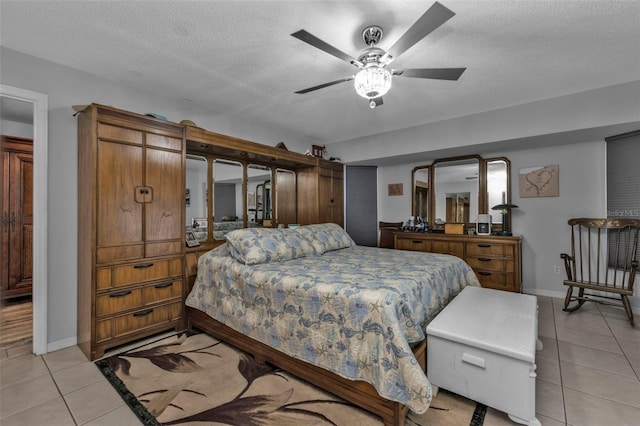 5198 White Ave, Port Charlotte, FL 33981 - bedroom with light tile patterned floors, baseboards, a textured ceiling, and a ceiling fan