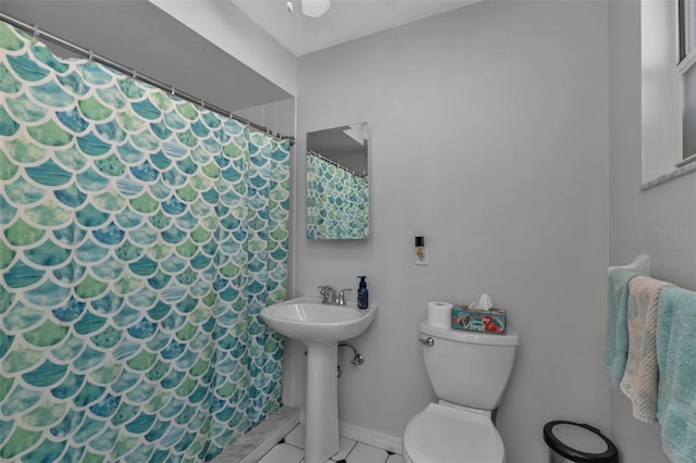 5198 White Ave, Port Charlotte, FL 33981 - bathroom featuring toilet, a shower with curtain, a sink, and baseboards