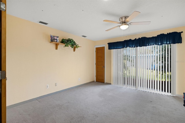 empty room featuring ceiling fan and light colored carpet