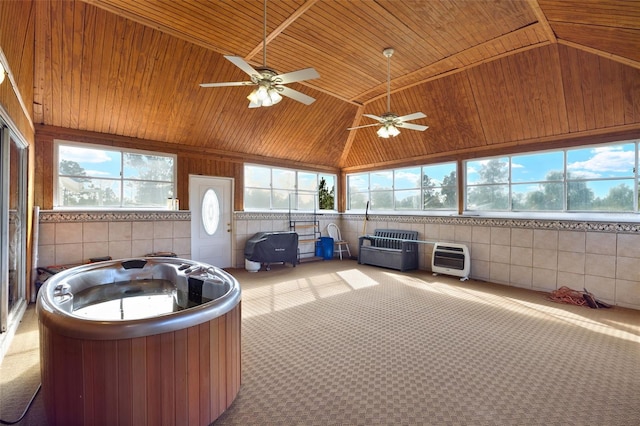 unfurnished sunroom featuring wood ceiling, heating unit, ceiling fan, a hot tub, and lofted ceiling