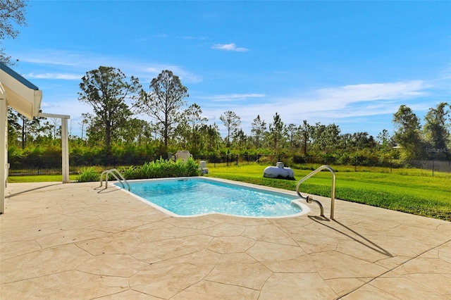 view of swimming pool featuring a yard and a patio