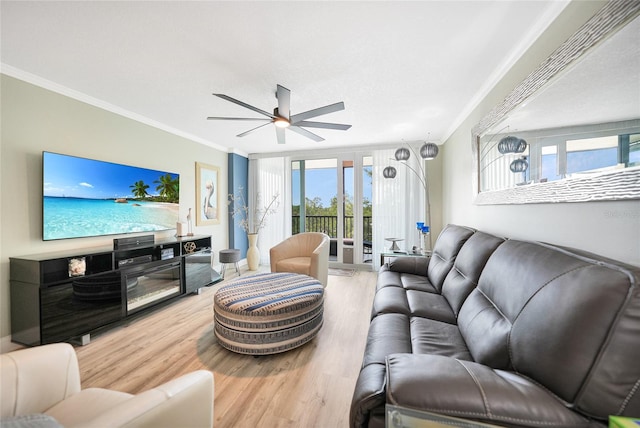 living room featuring hardwood / wood-style floors, ceiling fan, and ornamental molding