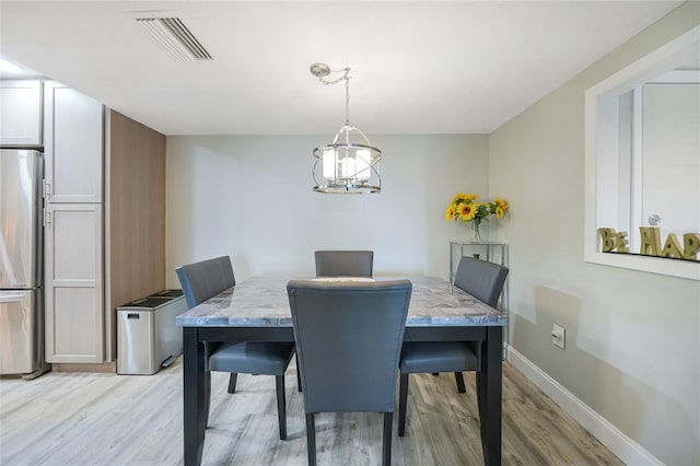 dining area with light hardwood / wood-style floors